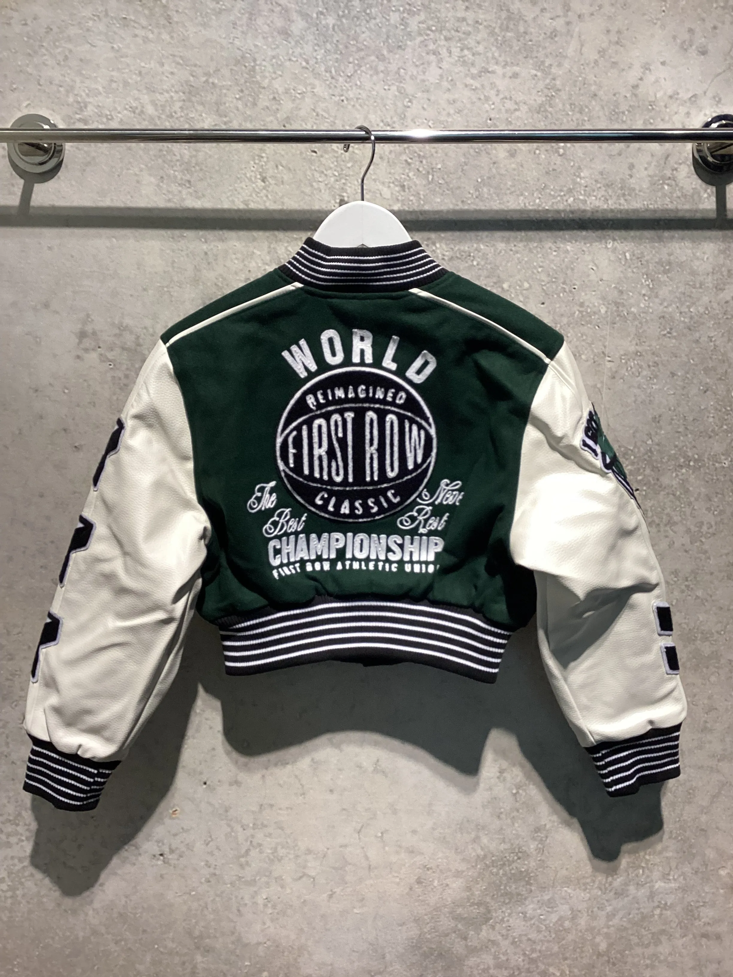 FIRST ROW: THE BEST NEVER REST CROPPED VARSITY JACKET